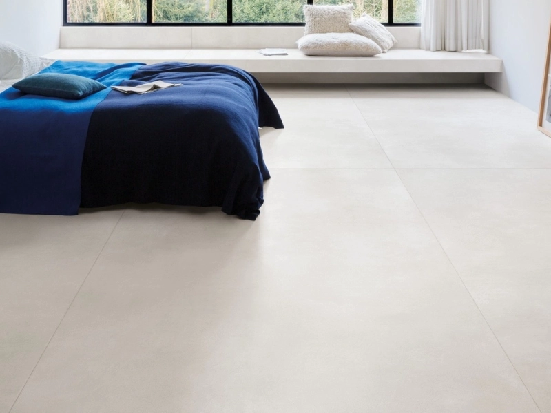 Płytki gresowe Marazzi Grande Concrete Look efekt beton w eleganckim salonie z dużymi przeszkleniami